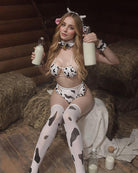 Cowgirl lingerie set with cow-print bra and panties, choker and matching wrist cuffs