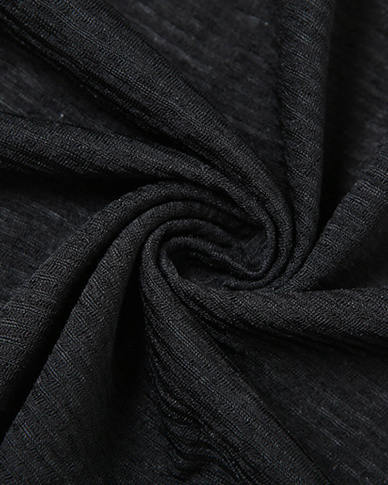 Black sheer fabric close-up with textured, woven pattern