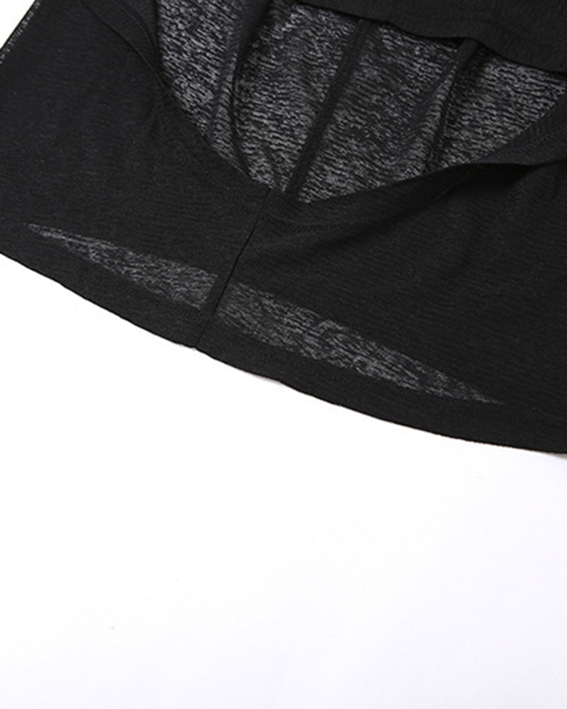 Black sheer fabric close-up showing hem seam and subtle shimmer