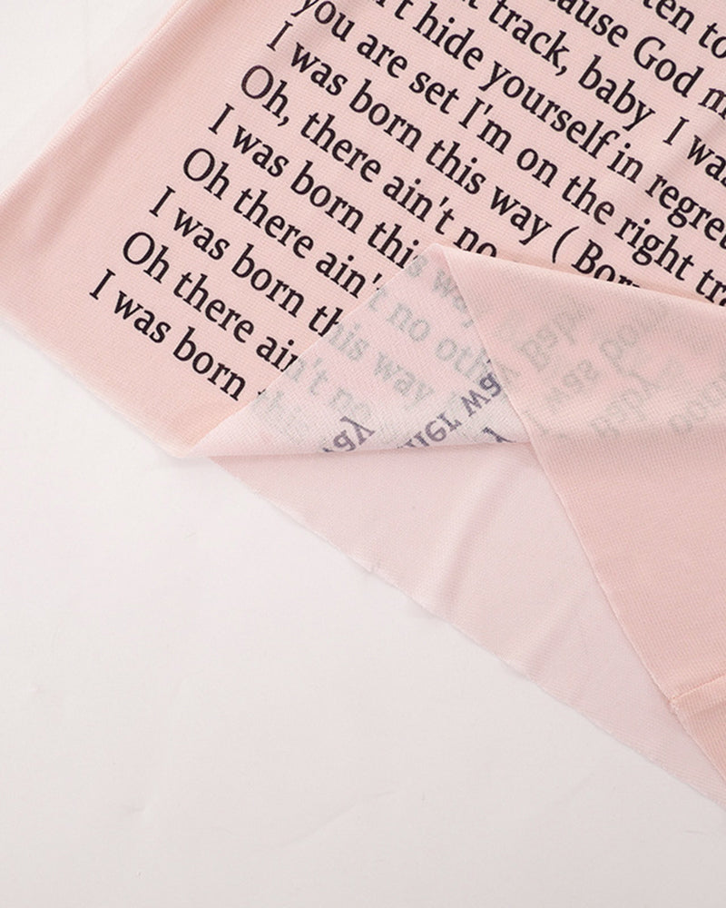 Sheer pink mesh fabric with black lyric text print