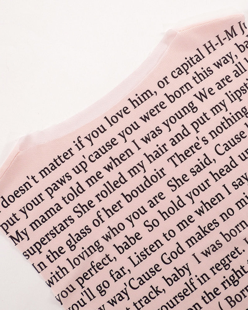 Sheer pink mesh with black lyric text print, close-up of lettering
