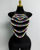 Multicolor beaded pom-pom body chain with several layered strands on mannequin