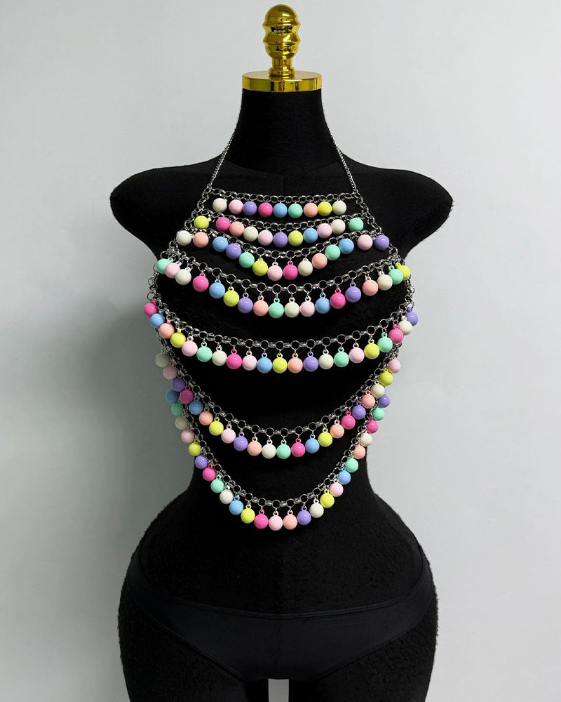 Multicolor beaded pom-pom body chain with several layered strands on mannequin