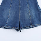 Blue denim halter romper with panel seams and cuffed shorts hem
