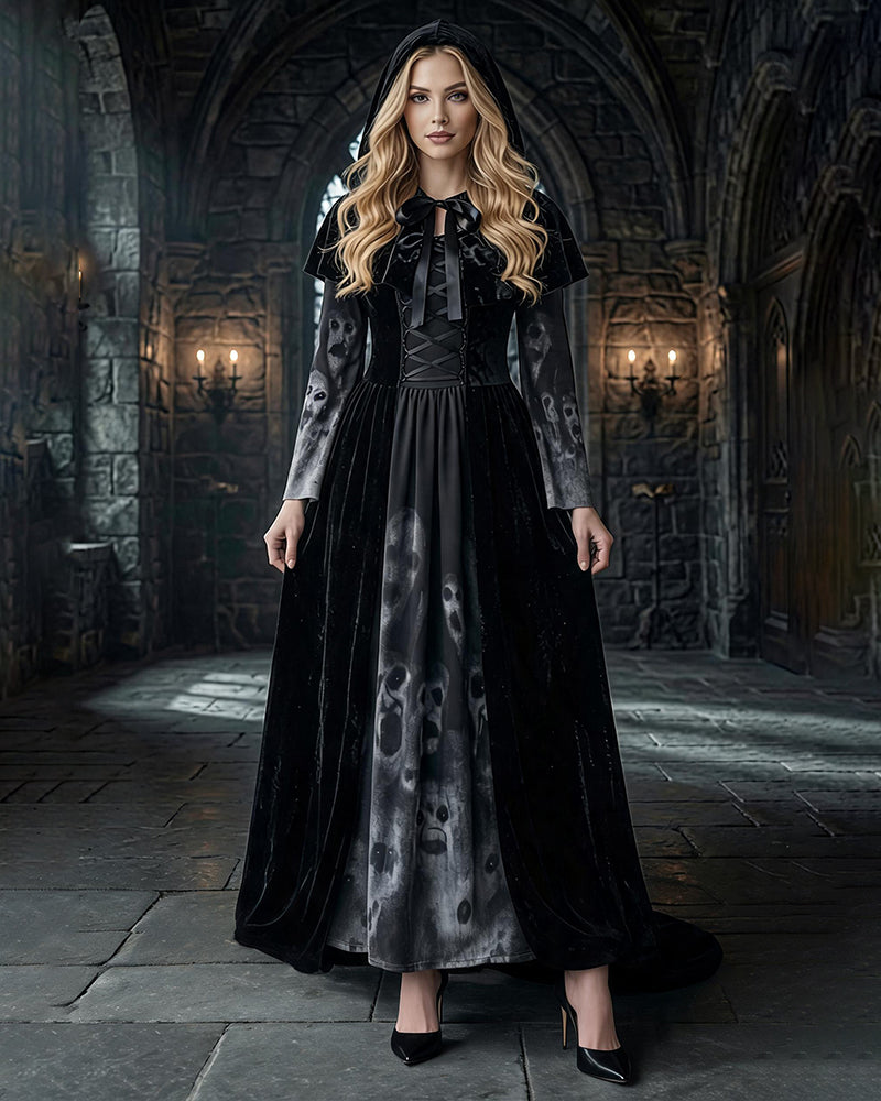 Black long sleeve maxi dress with gray skull-print skirt, tie-neck, hooded cape overlay