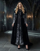 Black long sleeve maxi dress with gray skull-print skirt, tie-neck, hooded cape overlay