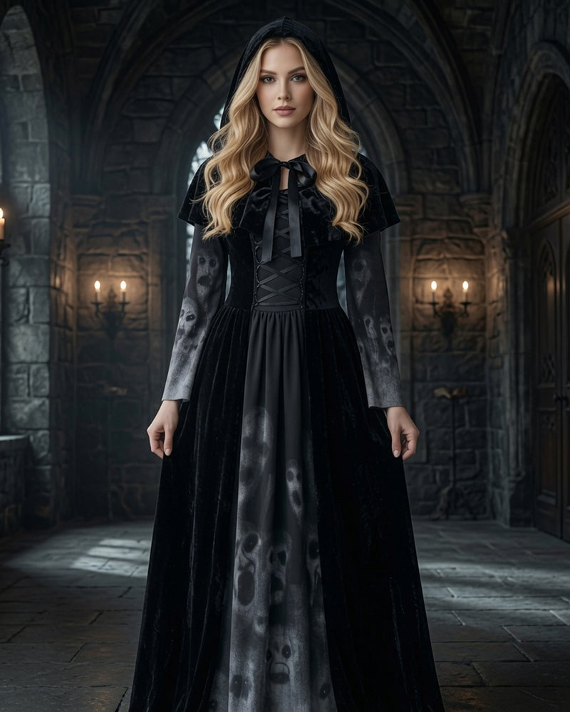 Black long sleeve maxi dress with skull-print panel, tie-neck bodice, attached cape