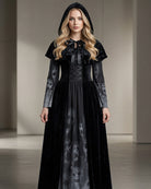 Black long sleeve maxi dress set with skull-print skirt, tie-neck, cape; full front view