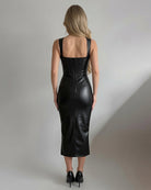 Back view of black faux leather sleeveless bodycon midi dress with square straps