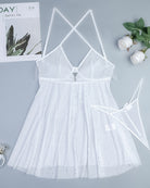 White sheer glitter mesh babydoll dress flat lay with crisscross open back straps