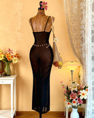 Black sheer mesh maxi lingerie dress on mannequin, thin straps and long bodycon silhouette