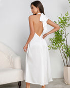 White satin halter maxi slip dress with bow at upper back and open V-back