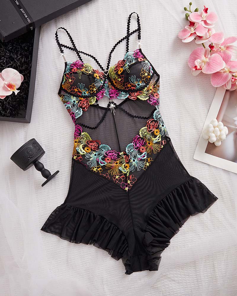 Black floral lace bodysuit on white, adjustable straps and ruched ruffle hem