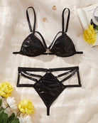 Black lingerie set laid flat: underwire bra with straps and high-waist brief