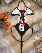 Black-and-white bunny bodysuit laid flat with red bow and ruffled trim