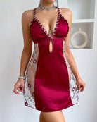 Wine red satin deep V halter mini dress with floral mesh side panels and tassel tie