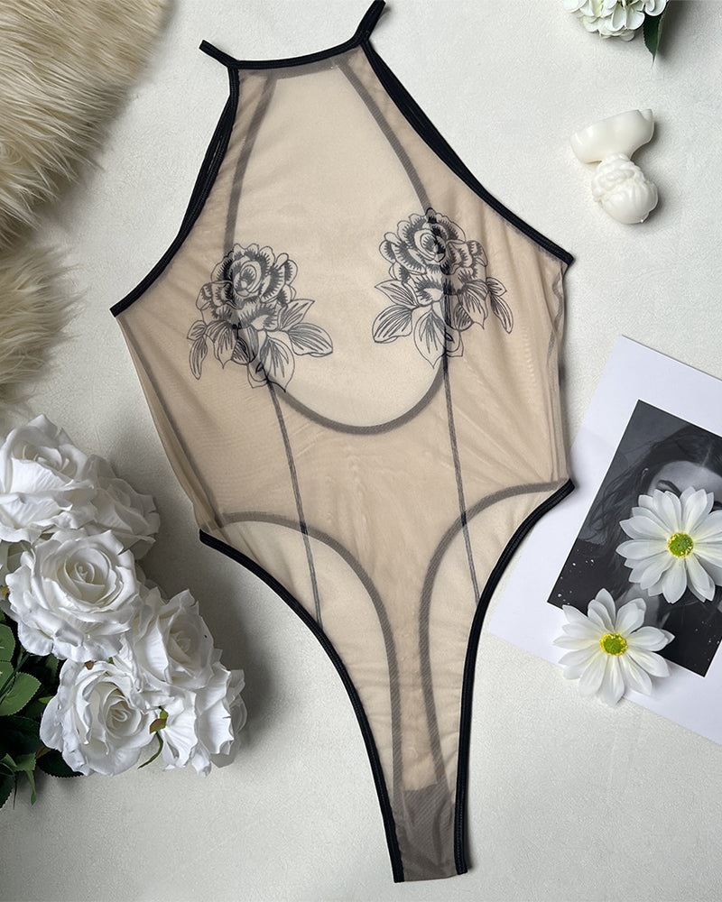 Sheer mesh rose print bodysuit with black trim and high-cut leg