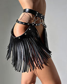Black PU mini wrap skirt with harness straps and dangling fringe