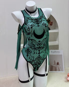 Teal mesh moon-print bodysuit with black garter straps and long sheer sleeves
