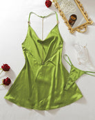 Green satin mini slip dress with V-back and thin straps, flat lay