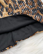 Close-up of leopard sequin mini dress fabric with dark inner lining