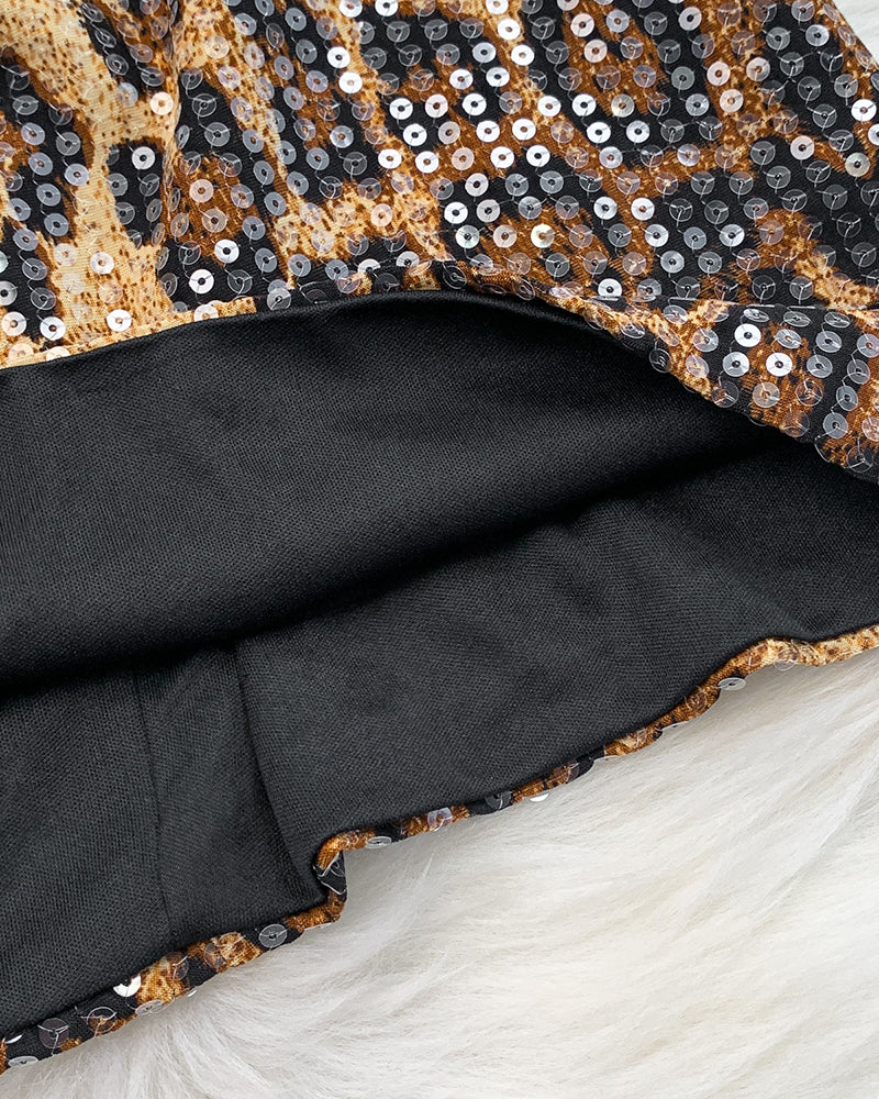 Close-up of leopard sequin mini dress fabric with dark inner lining