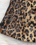 Leopard sequin pattern close-up with black, tan, and gold sparkle