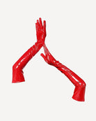 Red faux leather opera-length gloves with glossy finish and long fingered coverage