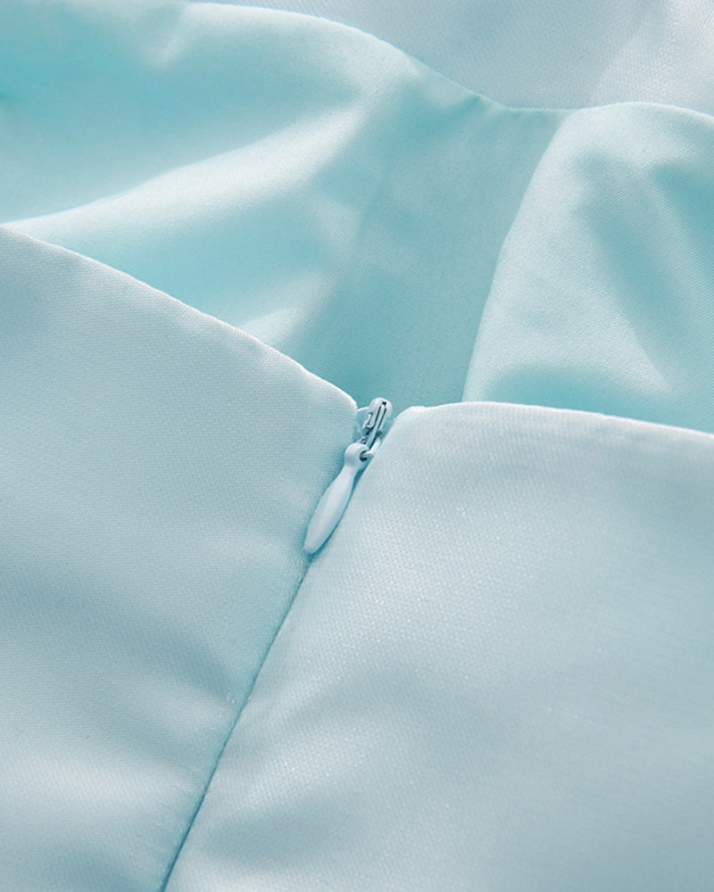 Sky blue corset bodice detail with smooth fabric seam and small button closure
