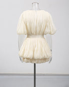 Champagne pleated mini dress with puff sleeves and gathered waist