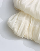 Champagne pleated fabric detail on a mini dress with tiered ruffle skirt