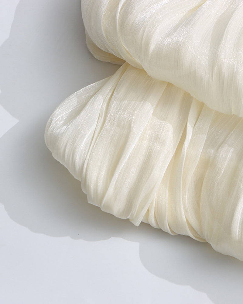 Champagne pleated fabric detail on a mini dress with tiered ruffle skirt