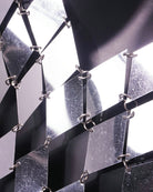 Silver chain-link PVC mesh close-up showing diamond-cut scales