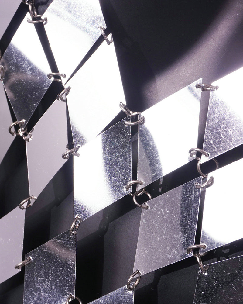 Silver chain-link PVC mesh close-up showing diamond-cut scales