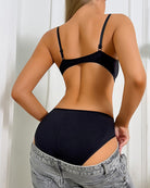 Black cutout bodysuit with spaghetti straps; open back with strappy details