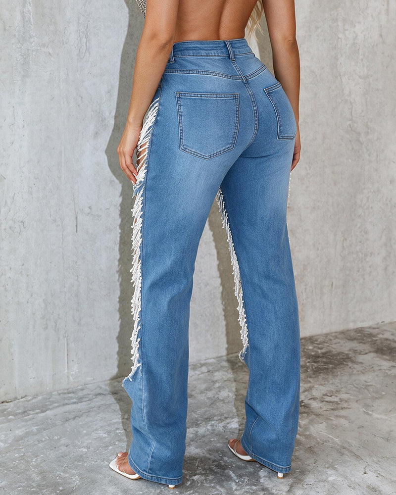 Light blue denim jeans with ripped details and frayed hem