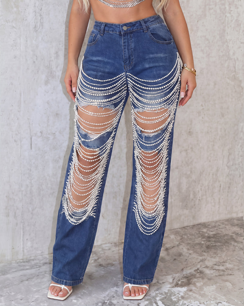 Light blue denim jeans with pearl chain drape across front