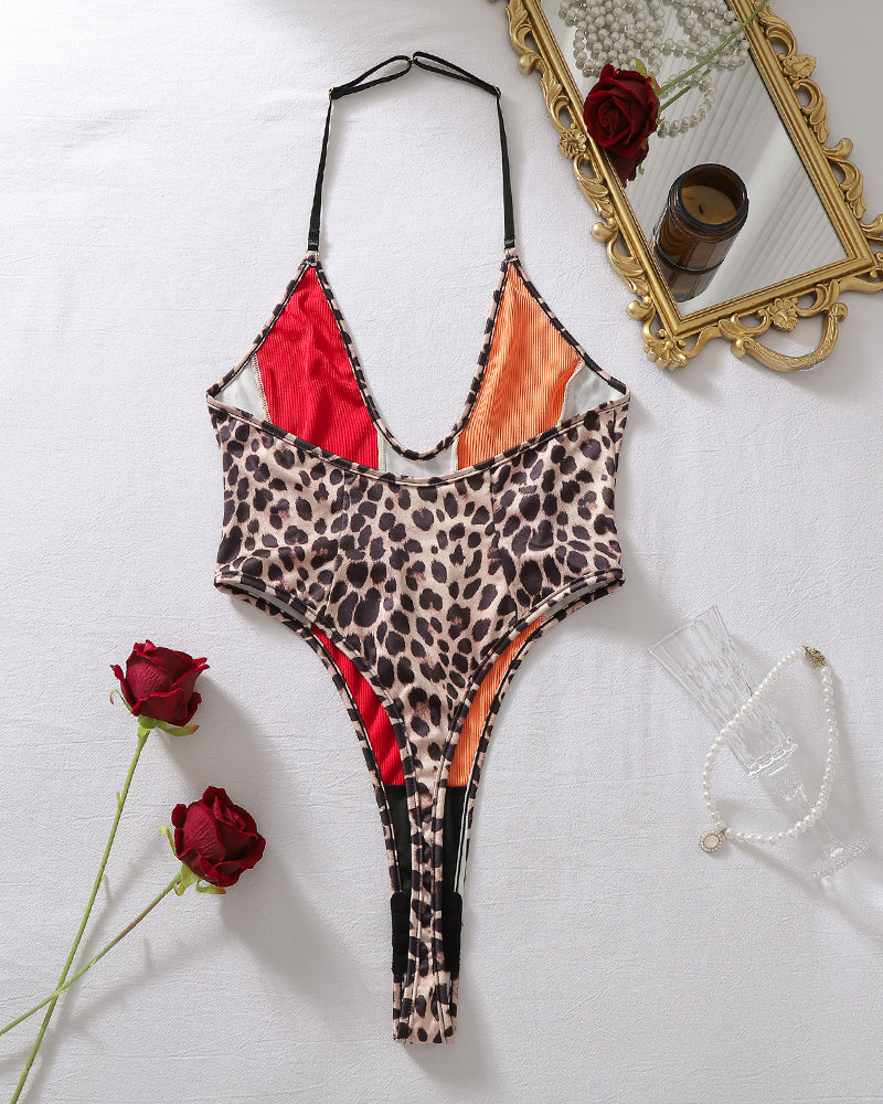 Halter one-piece swimsuit flat lay, leopard print colorblock with red and orange panels