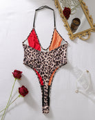 Halter one-piece swimsuit flat lay, leopard print colorblock with red and orange panels