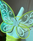 Glitter butterfly wings in green and blue with swirled white filigree and flower center