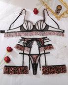 Flat lay leopard print lace lingerie set with bra, garter belt, thong, and four garter straps