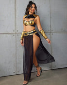 Black maxi skirt and metallic gold belt with off-shoulder bra top and arm cuffs
