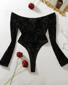 Black velvet off-shoulder bodysuit with long flared sleeves and floral damask texture