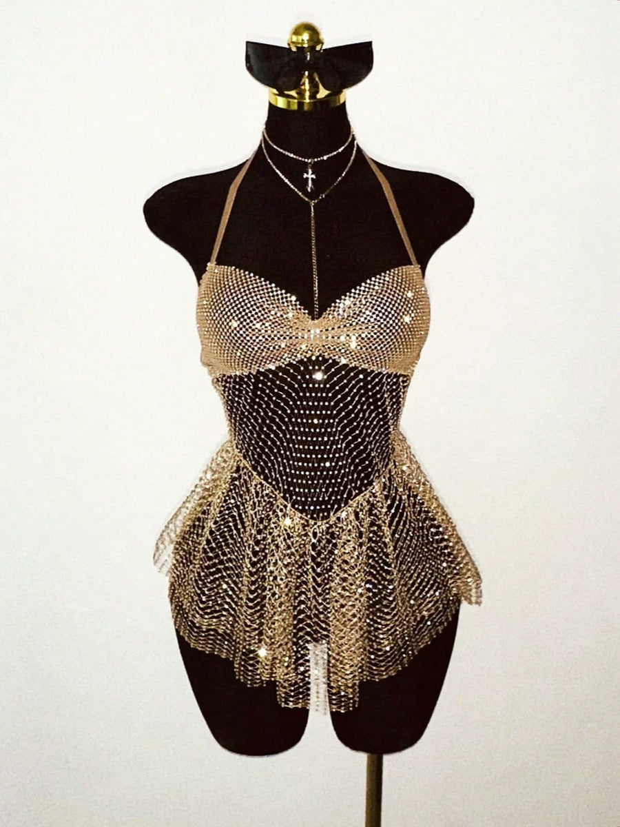Gold rhinestone halter mini dress with mesh fringe hem on a mannequin