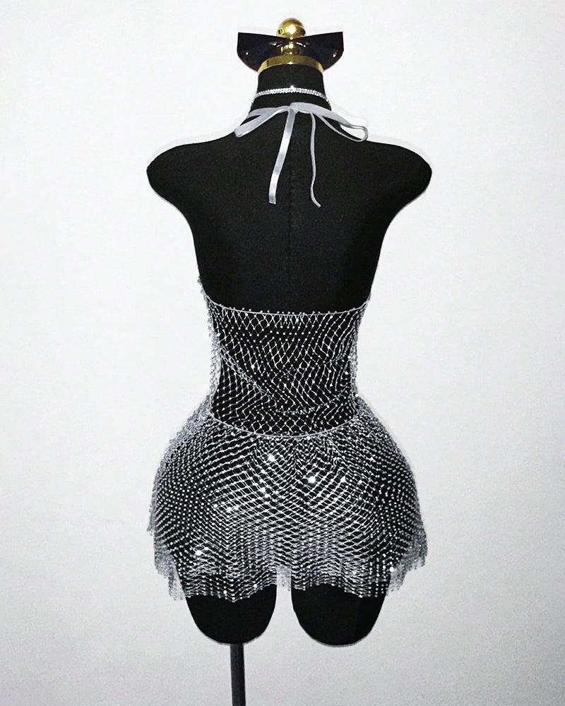 Back view: silver mesh halter mini dress with rhinestone fringe hem on mannequin