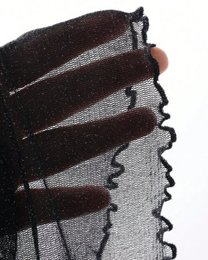 Black glitter sheer fabric close-up with scalloped edge trim