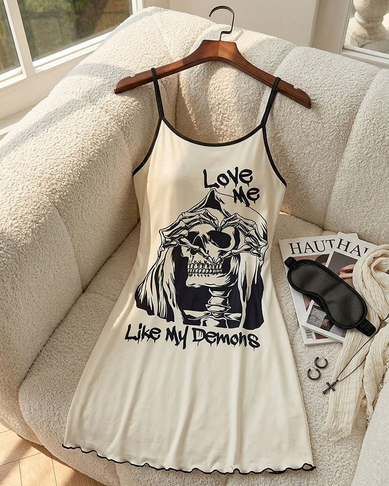 Cream spaghetti-strap mini slip dress on hanger with skull graphic and scalloped hem