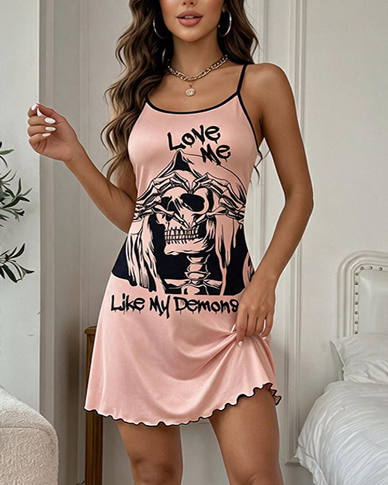 Pink mini slip dress with skull graphic front, spaghetti straps, scalloped hem