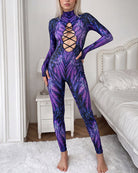 Front-view purple feather-print catsuit with long sleeves and lace-up cutout