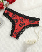 Red lace-trim thong panty with black skull and bat print
